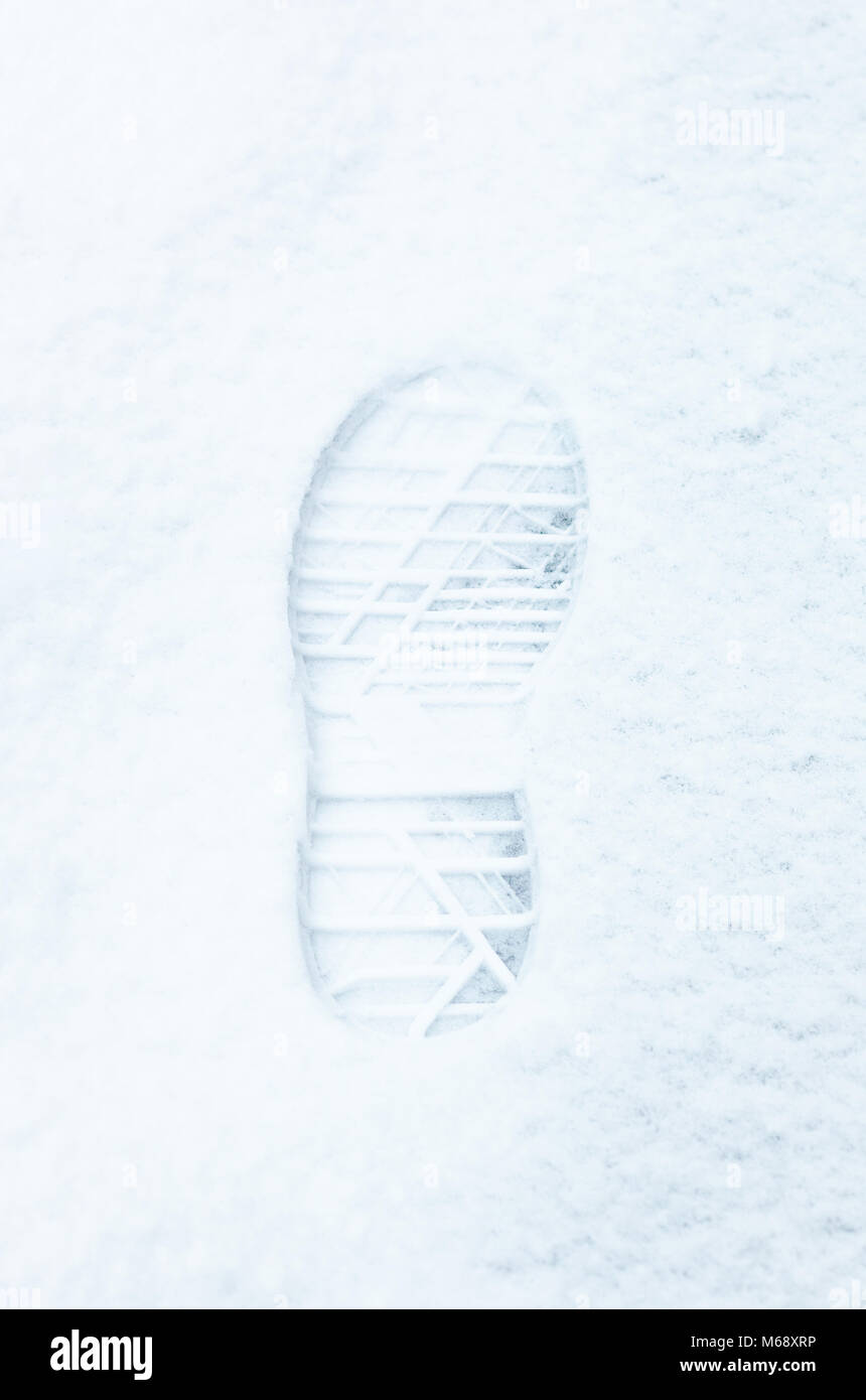 Single footprint in the fresh snow. Top view. Stock Photo