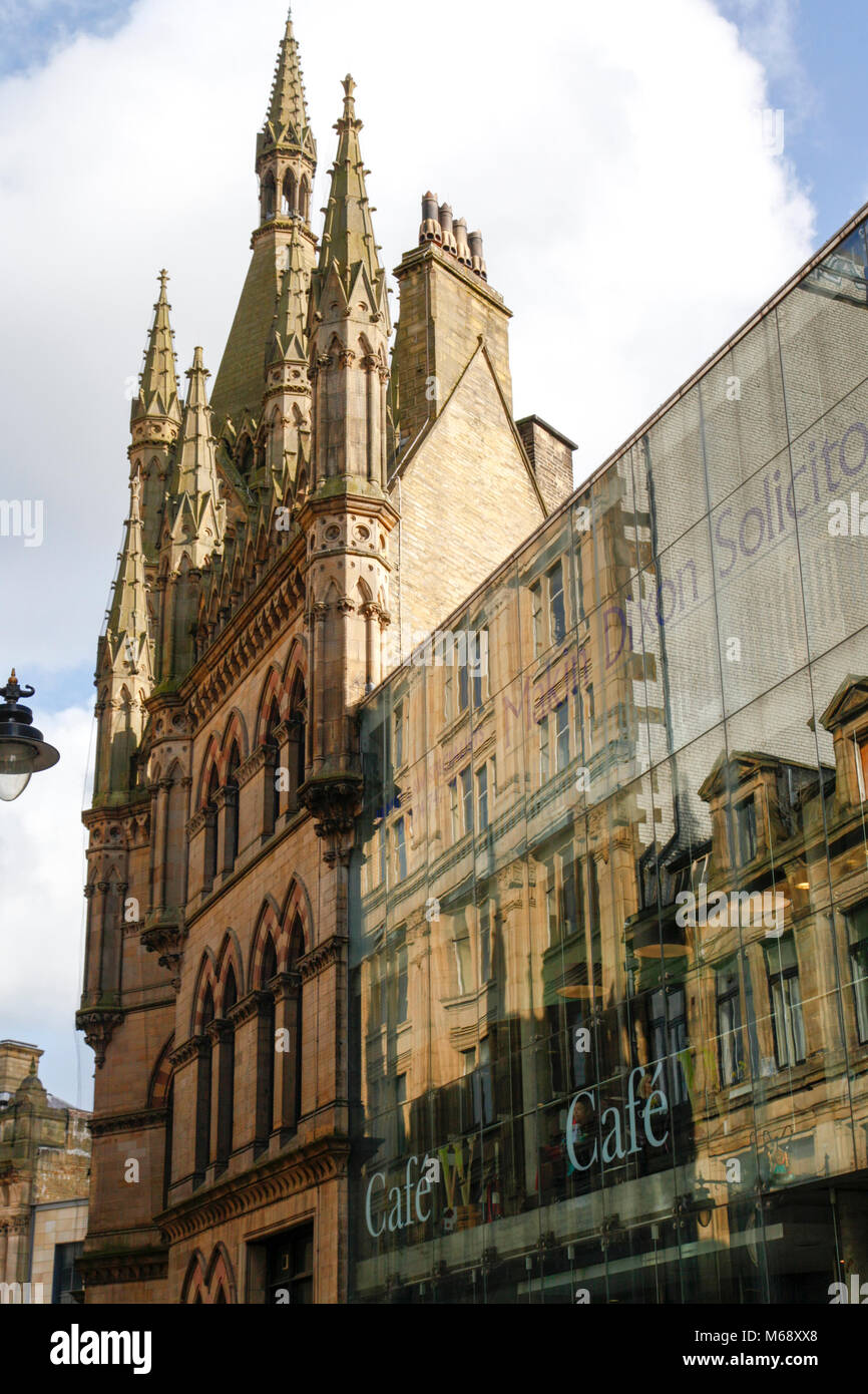 Reflections in the glass frontage of the Wool Exchange building, now the home of Waterstones, in Bradford, West Yorkshire Stock Photo