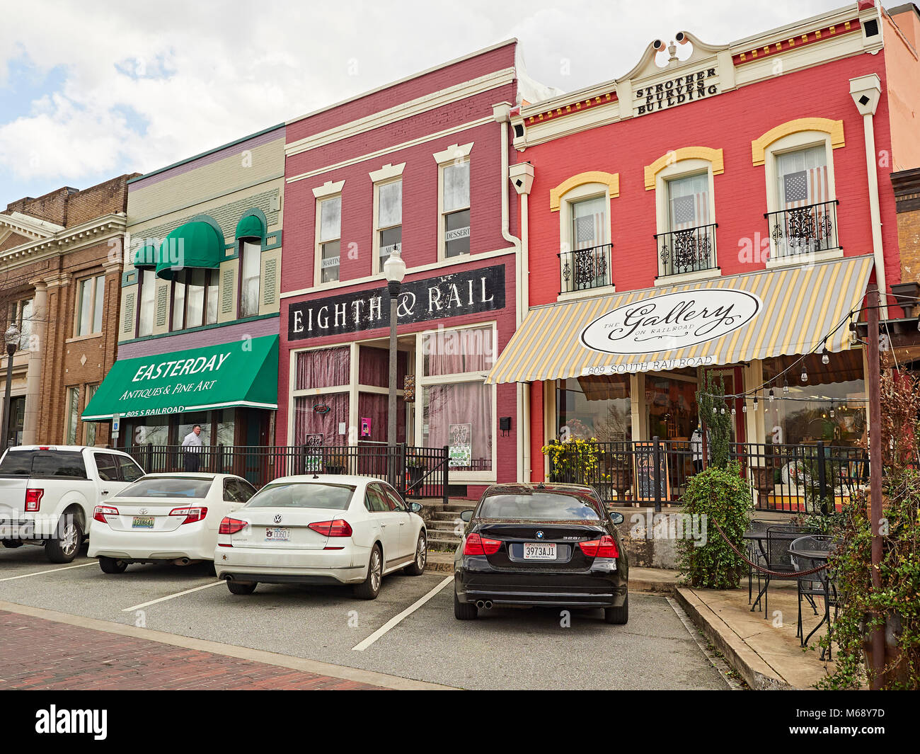 Small quaint shops with fancy storefronts in small town America line the street in Opelika Alabama, USA. Stock Photo