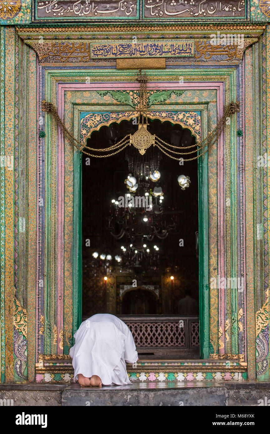Srinagar, India - June 15, 2017: Unidentified muslim man pray at the entrance to the Khanqah-e-Moula ancient mosque in old town of Srinagar, Jammu and Stock Photo
