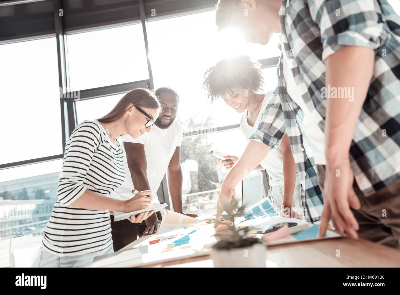 Happy young people working together Stock Photo