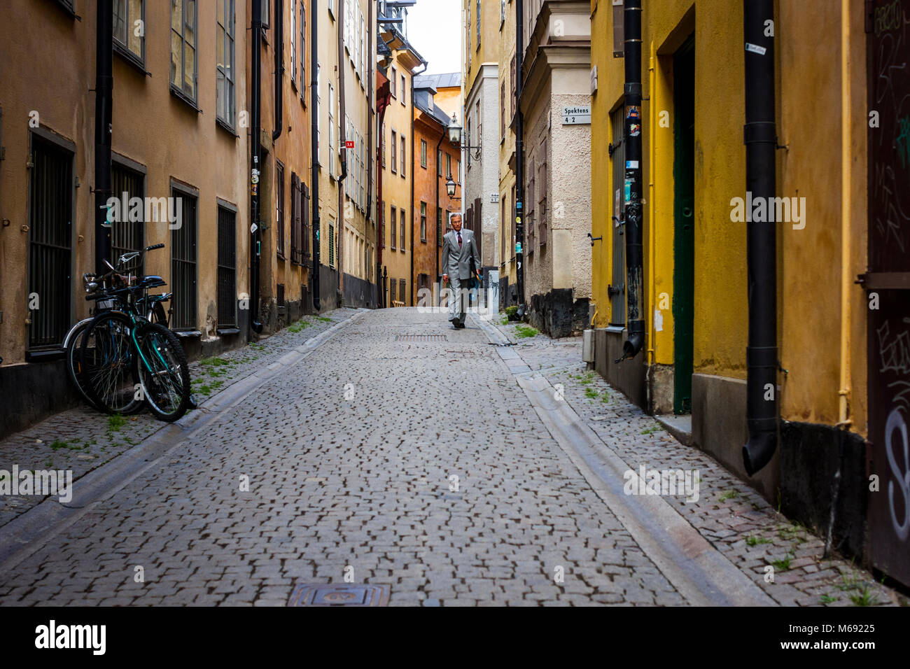A businessman walks through Gamla Stan in Stockholm, Sweden. Stock Photo