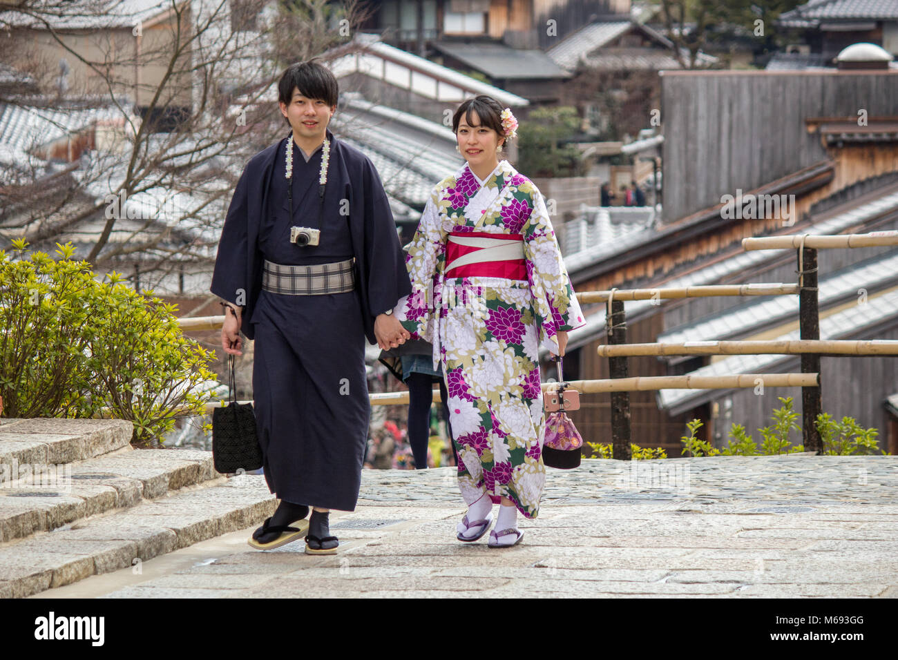 A couple who have hired traditional Japanese costumes are pictured in the Gion area of Kyoto, Japan near the Kiyomizu-dera Buddhist Temple. Stock Photo