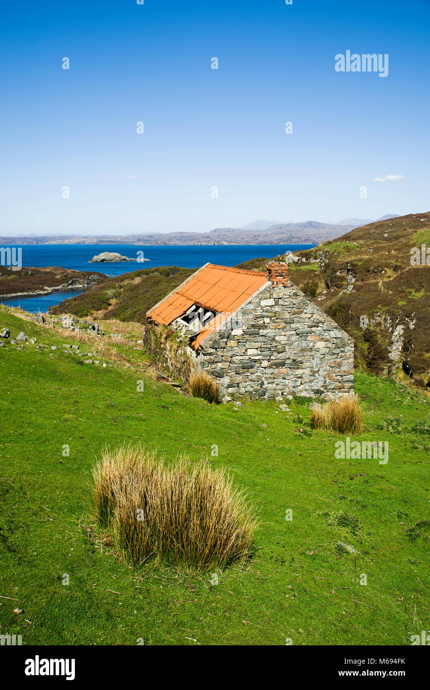 Old derelict abandoned croft house with corrugated iron roof at the coastal settlement of Drumbeg, Assynt, Sutherland, Scottish Highlands, Scotland UK Stock Photo