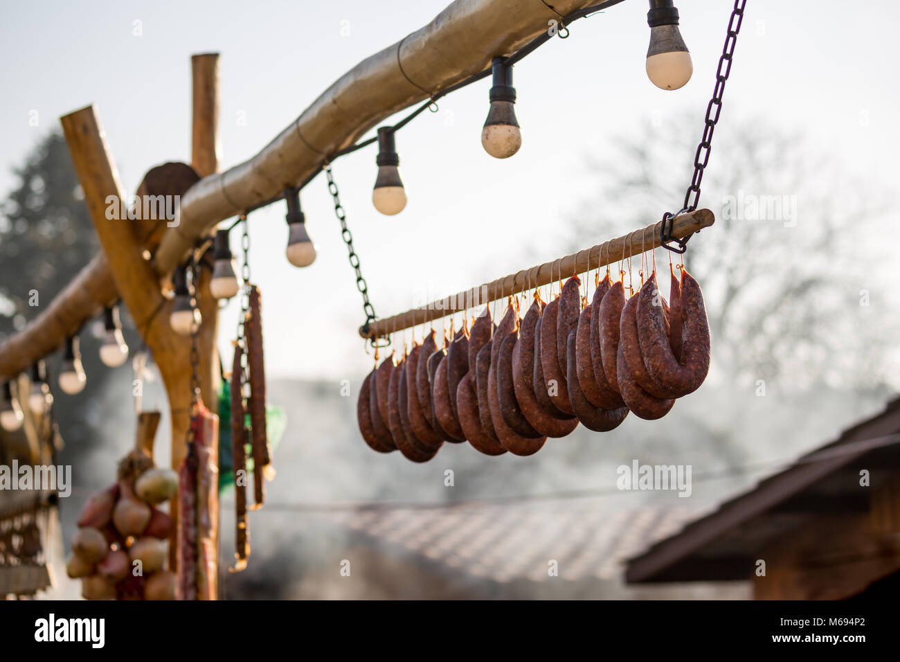 Hanging home made pork sausages outside Stock Photo