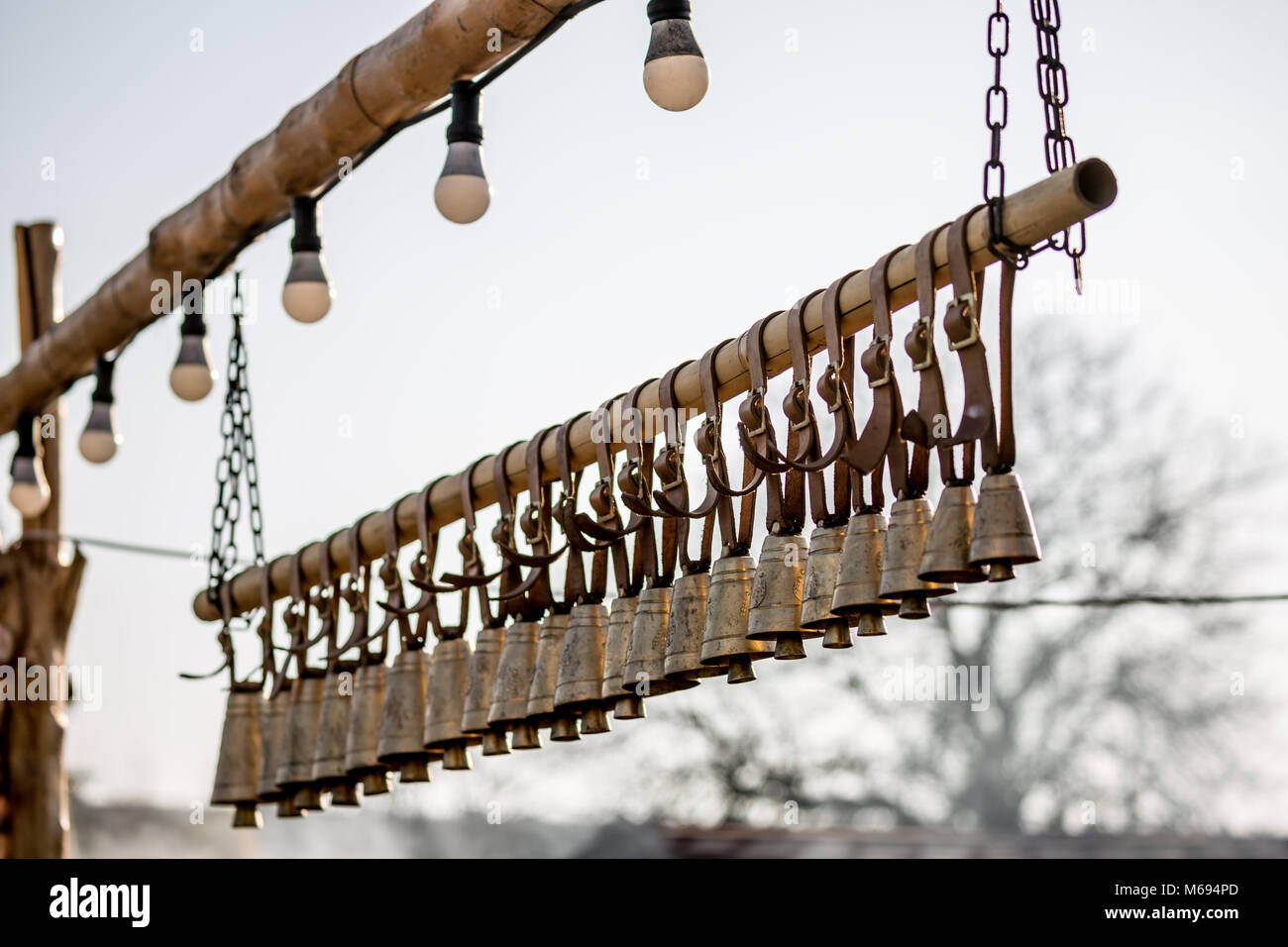 Traditional ritual brass bells hanging outside in a row Stock Photo Alamy