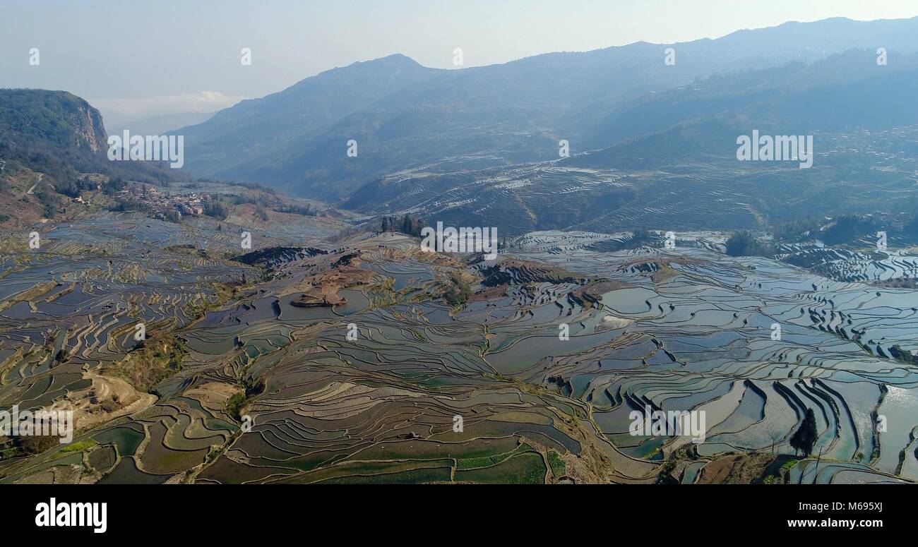 View into a valley showing the magnificent Yuanyang Rice Terraces sloping down the mountainsides. UNESCO World Cultural Heritage Site Stock Photo