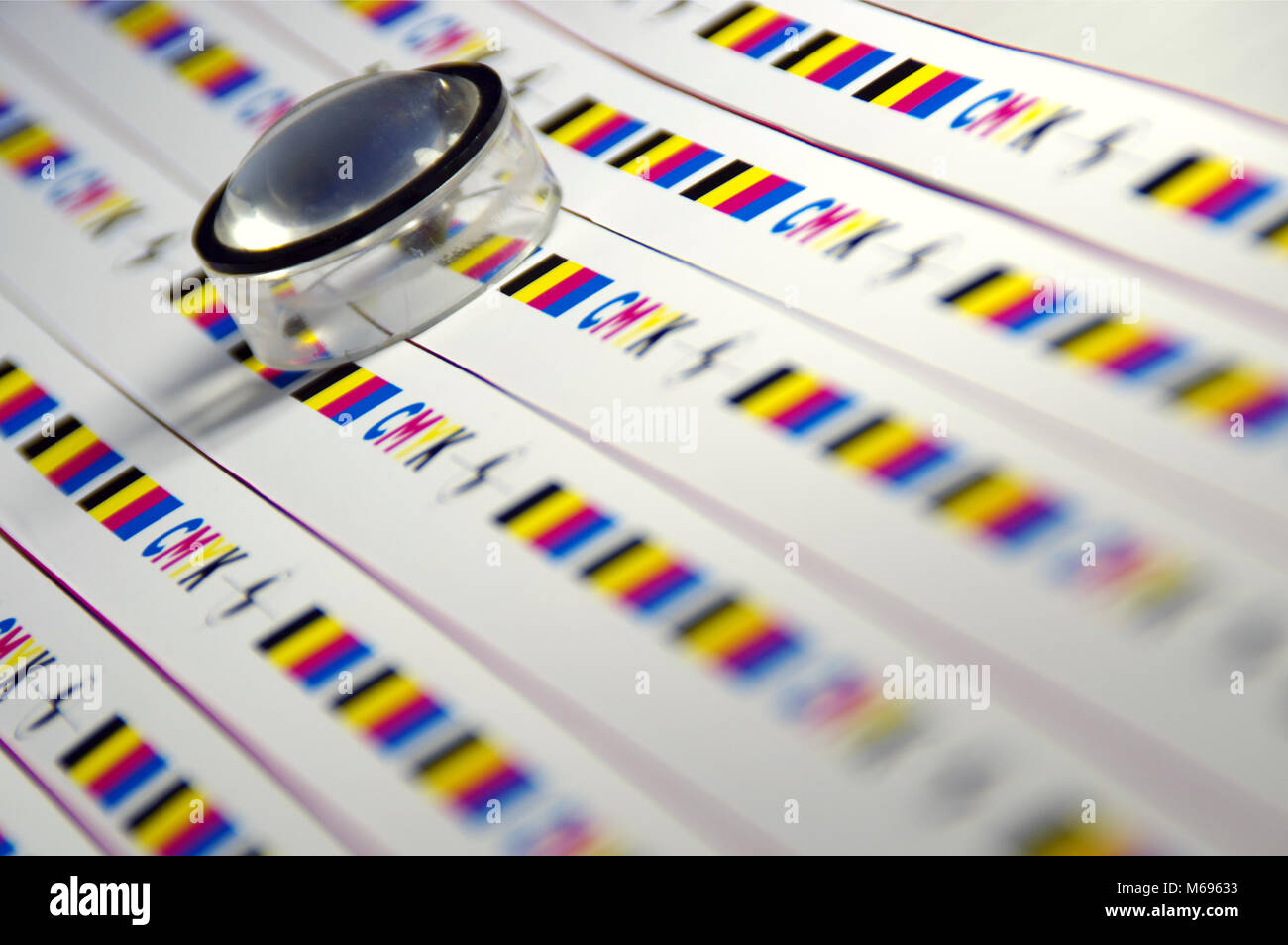Magnifier on plotter test printout. Checking cmyk print quality. Stock Photo