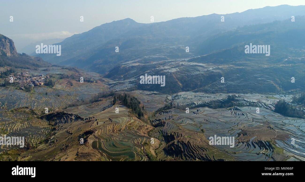 View into a valley showing the magnificent Yuanyang Rice Terraces sloping down the mountainsides. UNESCO World Cultural Heritage Site Stock Photo