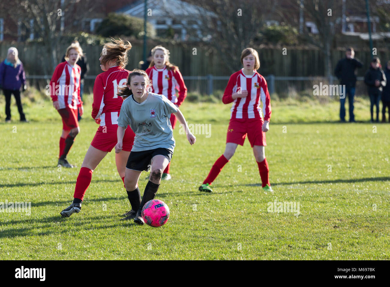 A young female / girl football player with ball Stock Photo