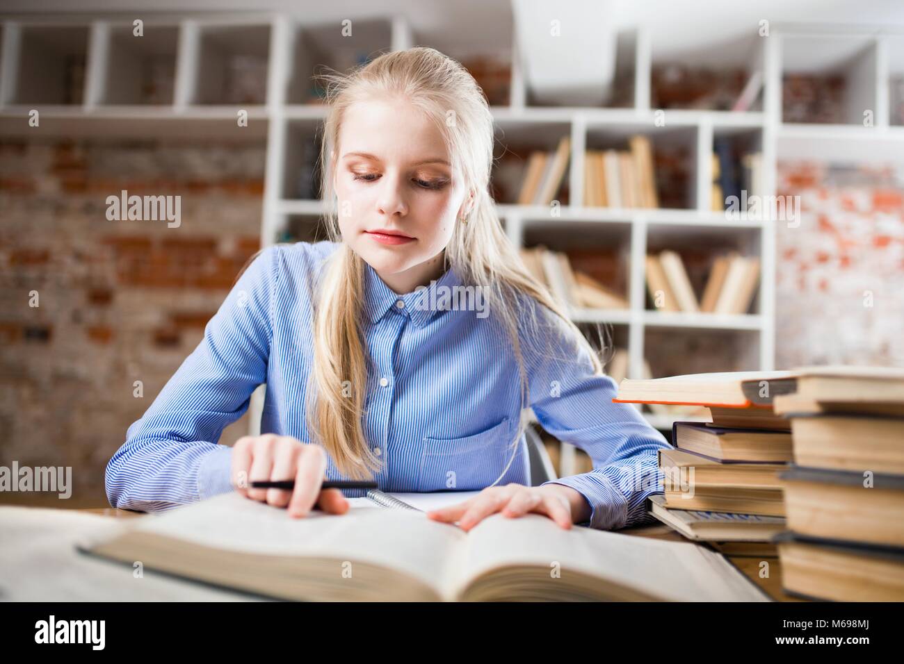 Teenage girl in a library Stock Photo - Alamy