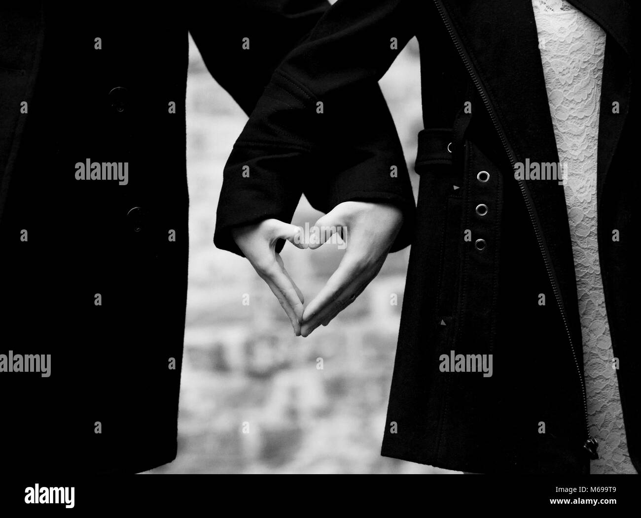 Couple making heart shape hands Black and White Stock Photos & Images ...