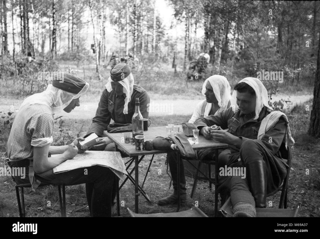 German soldiers wearing Mosquito protection nets on their heads in forest Near Babruysk USSR in June 1941 at the start of German invasion of Russia in WW2. Stock Photo