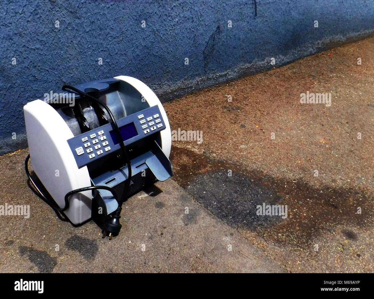 Feeling unwanted. Discarded office machine pavement Stock Photo