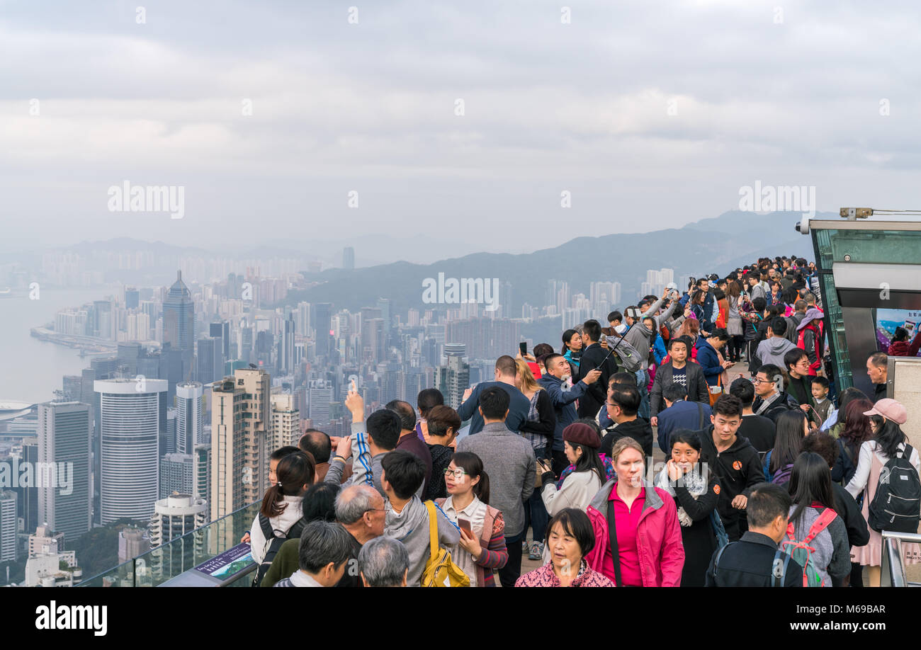 18 February 2018 - Hong Kong. Tourists at Victoria Peak taking photographs and selfies of Hong Kong skyline. Stock Photo