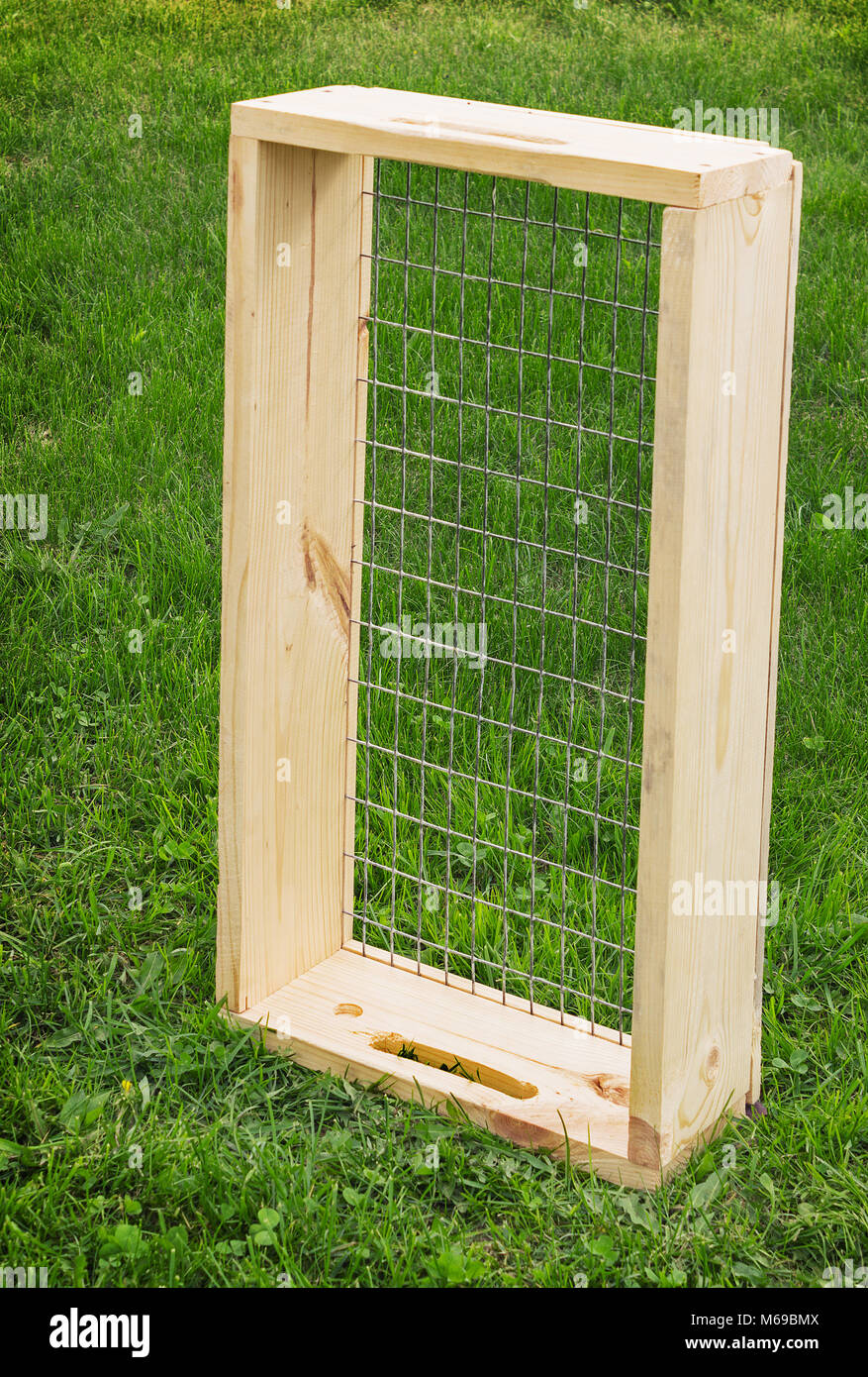 Sieve with a wooden frame for garden works Stock Photo Alamy