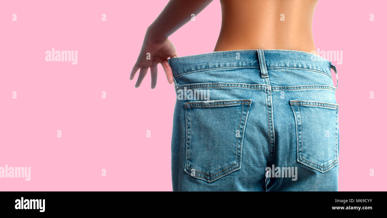 Woman in oversize jeans after weight loss. Female bottom in oversize
