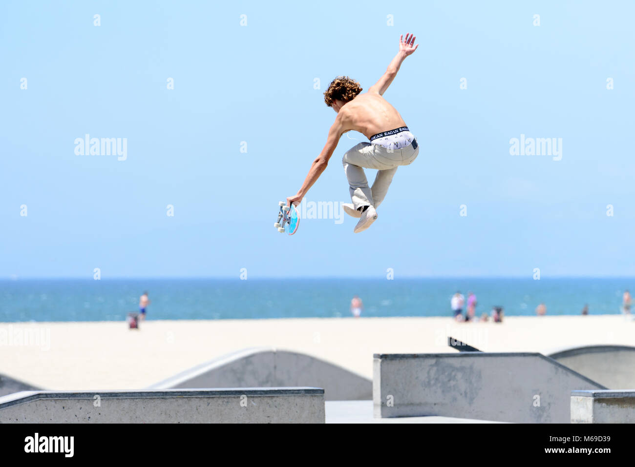 Young skateboarder at the skatepark on world famous Venice Beach Boardwalk one of the most popular attraction of California. Stock Photo