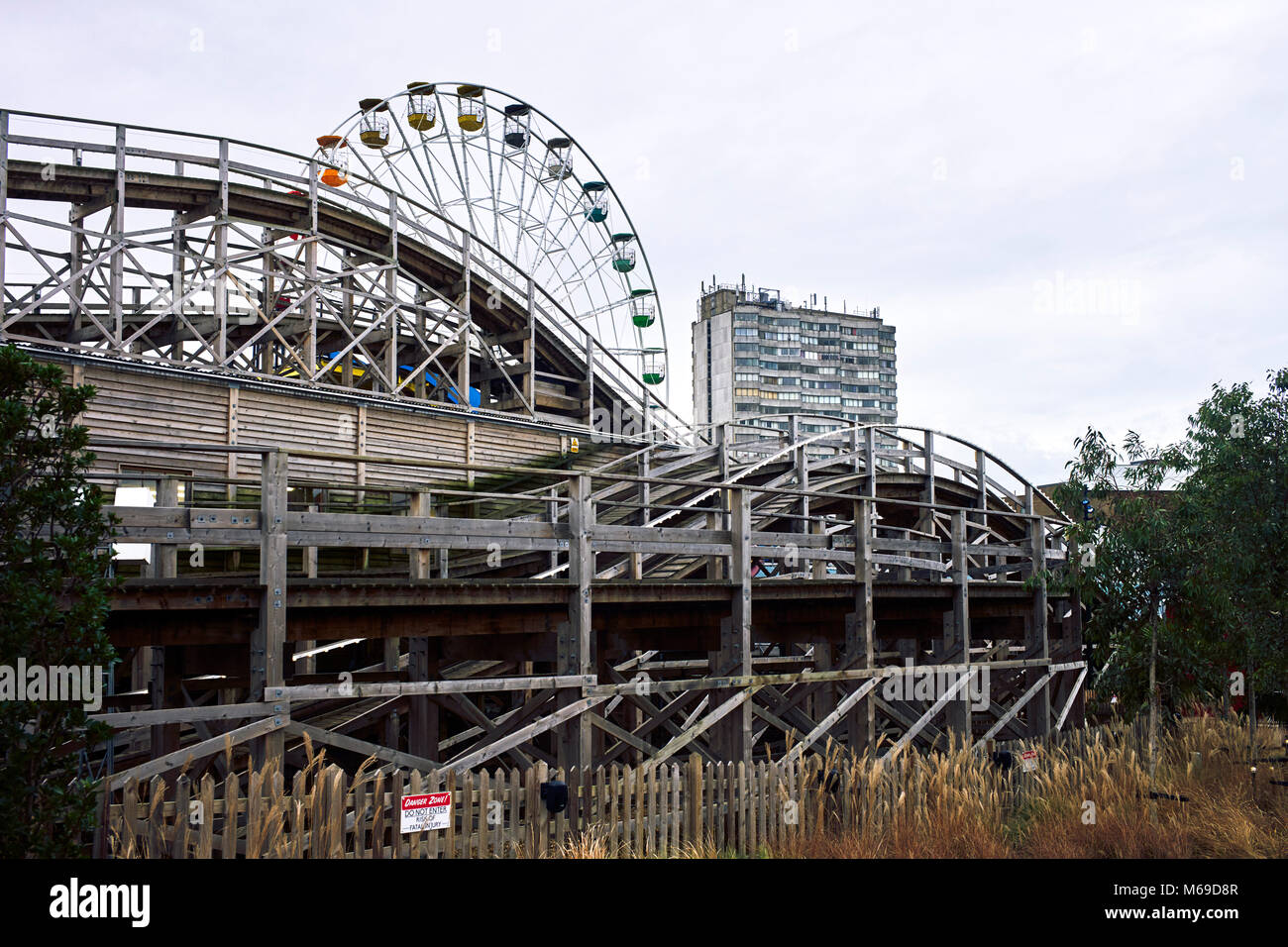 Big wheel and roller coaster with block of flats in background at Dreamland, Margate Stock Photo