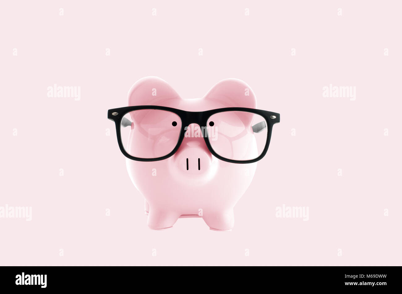 Front view. Pink piggy bank in glasses on pastel pink background Stock ...