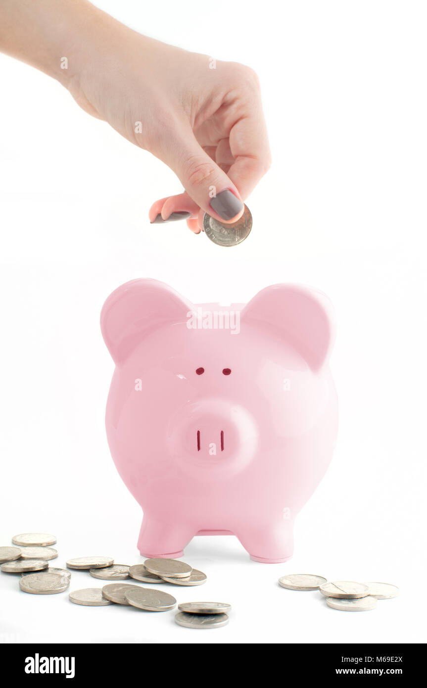 Savings concept. Female hand putting coin into piggy bank isolated on ...