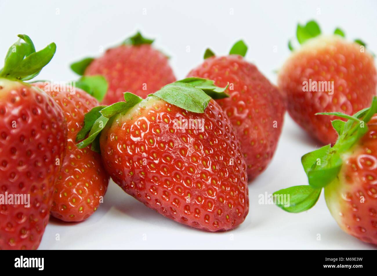 Strawberries on white background in macro view Stock Photo - Alamy