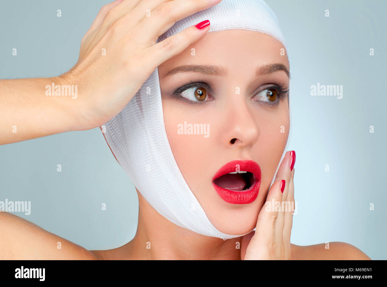 Beautiful woman after plastic surgery with bandaged face. Beauty