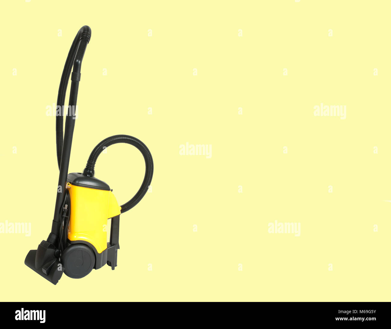 Yellow vacuum cleaner on pastel yellow background Stock Photo Alamy