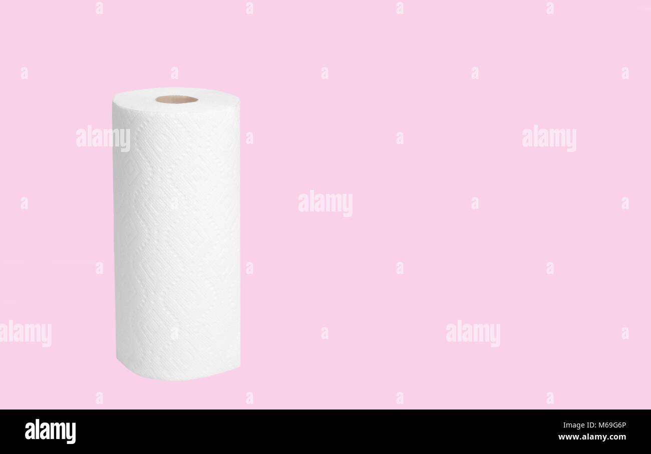 Roll of paper towel for housework on pastel pink background Stock Photo