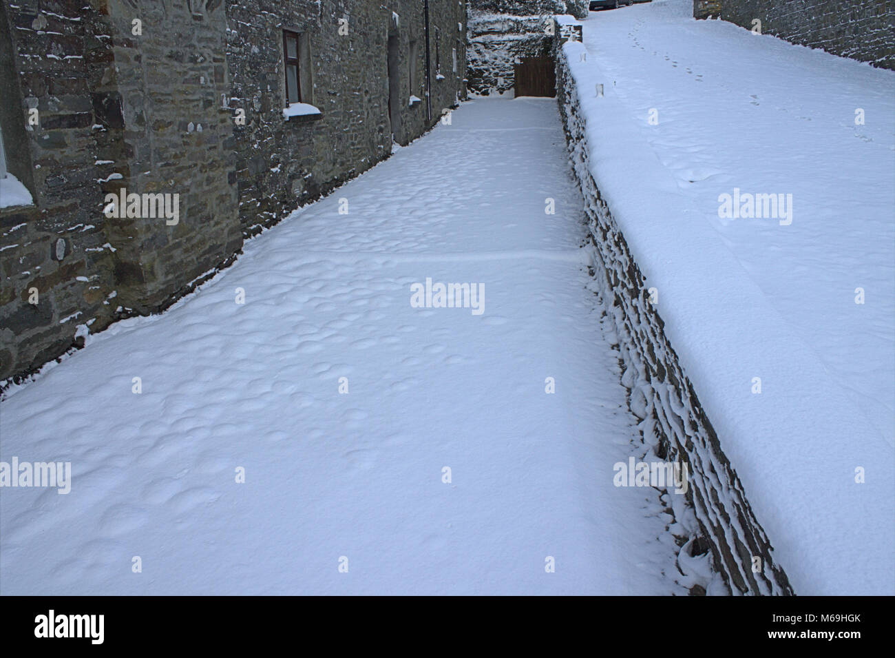 Pristine undisturbed fresh snow on a sidewalk or footpath after overnight snowfall. Stock Photo