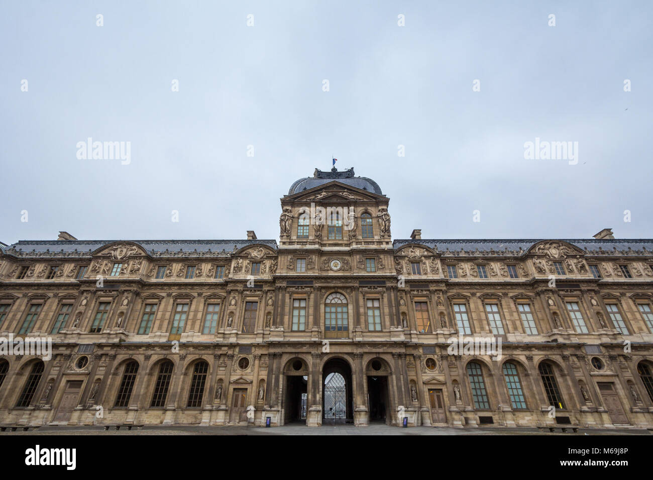 Courtyard of Louvre Palace (Palais du Louvre) in Paris, France, taken during a cloudy afternoon. This former royal palace is now one of the biggest ar Stock Photo
