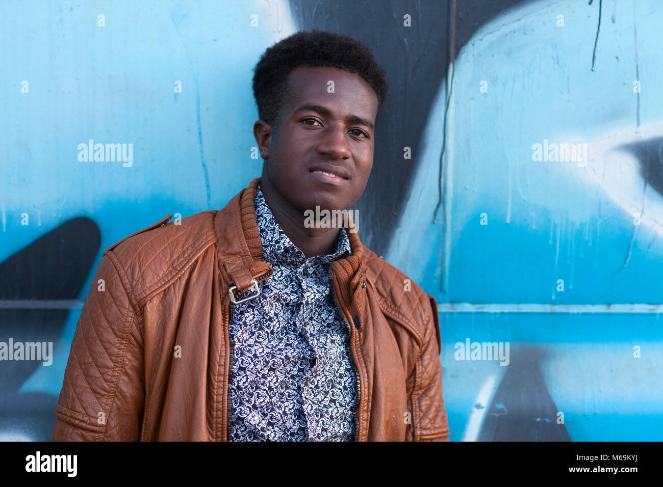 Handsome Young Black Man In Front Of Blue And Black Painted Metal