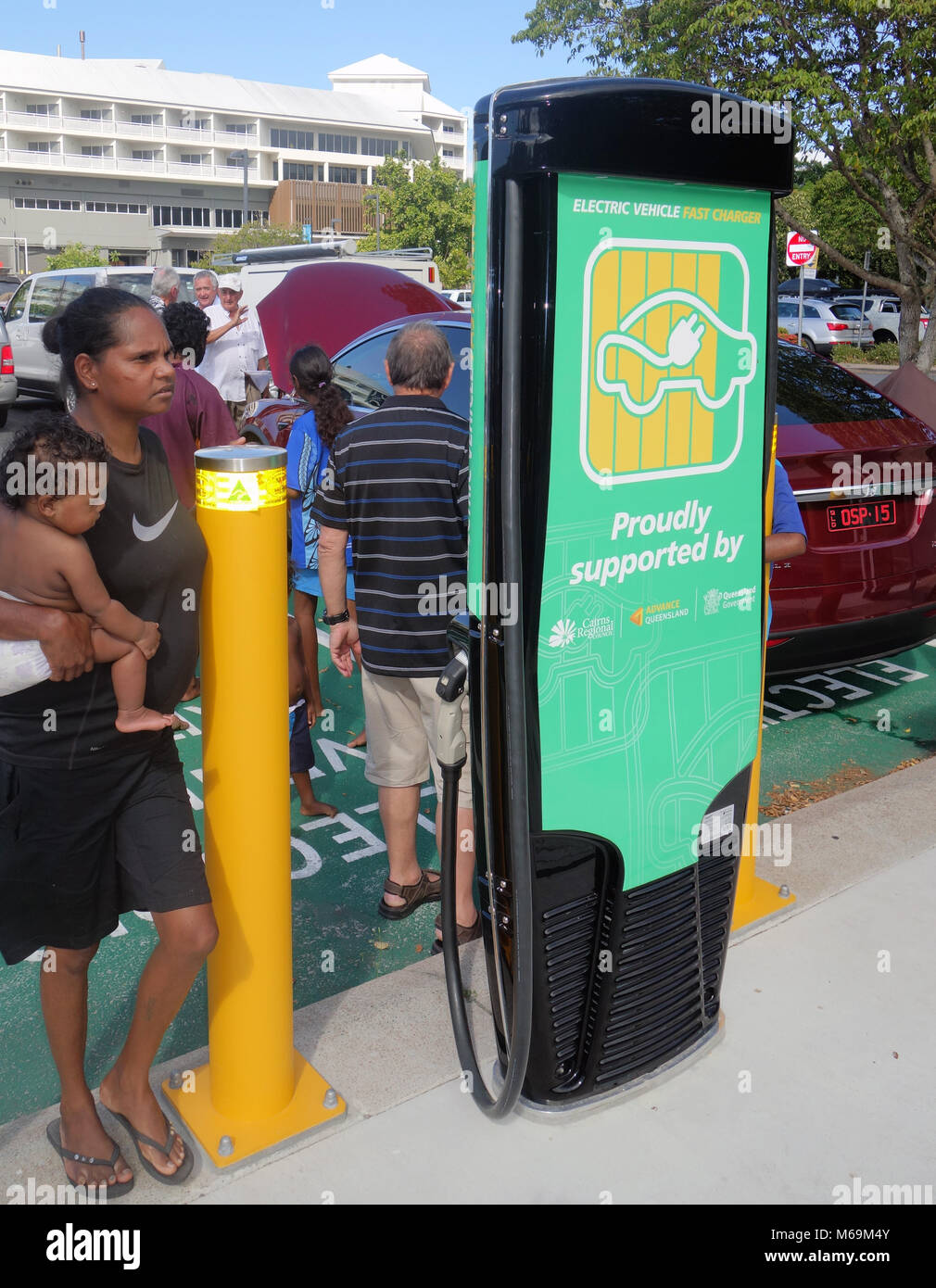 Locals checking out Tesla vehicle at new electric charging station, The Esplanade, Cairns, Queensland, Australia. No MR or PR Stock Photo
