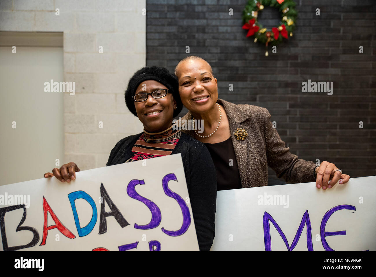 Philadelphia, Pennsylvania / USA: Jules Spencer and partner, Jazz Gray-Sadler of West Mount Airy work on a sign together at Taller Puertorriqueño ahead of the Womens March on Philadelphia. Jules and Jazz were photographed at the 2017 march which serves as the banner image for tonight's sign-making event. January 17 2018. Stock Photo