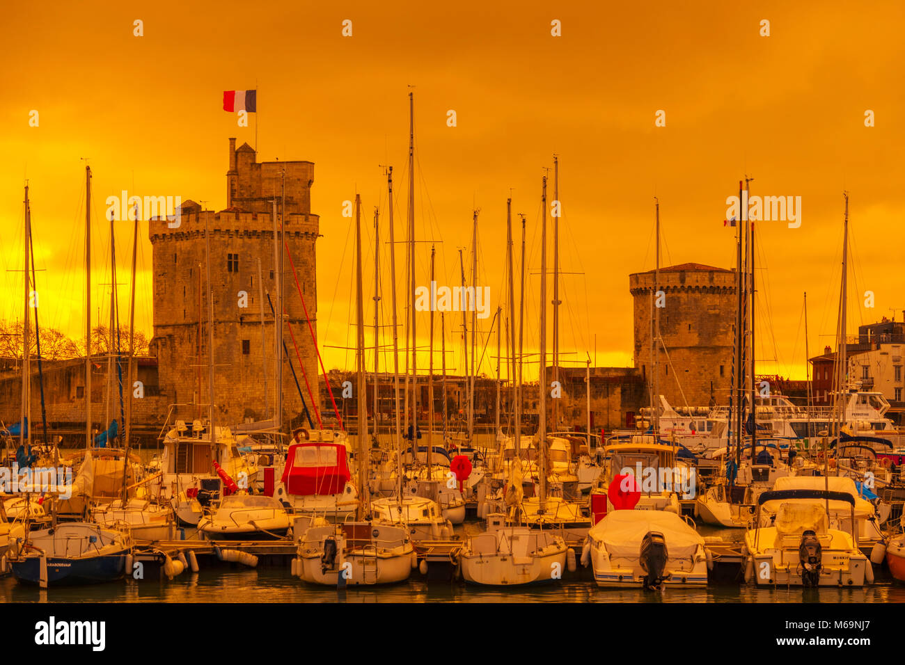 The old port with SaintNicolas Tower and Chain Tower at sunset. La