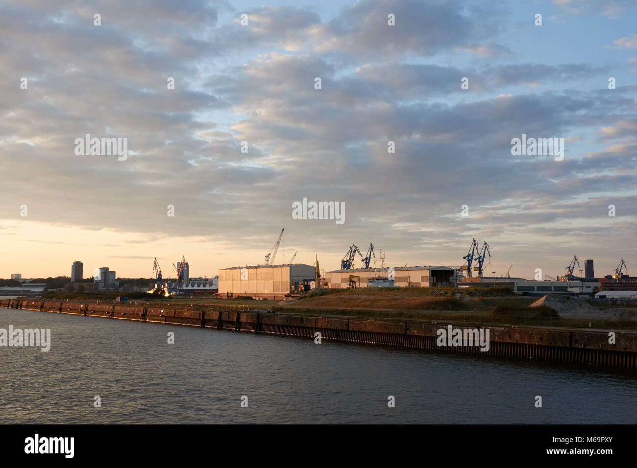 Seaport of Hamburg at sunset with beautiful evening sky. Stock Photo