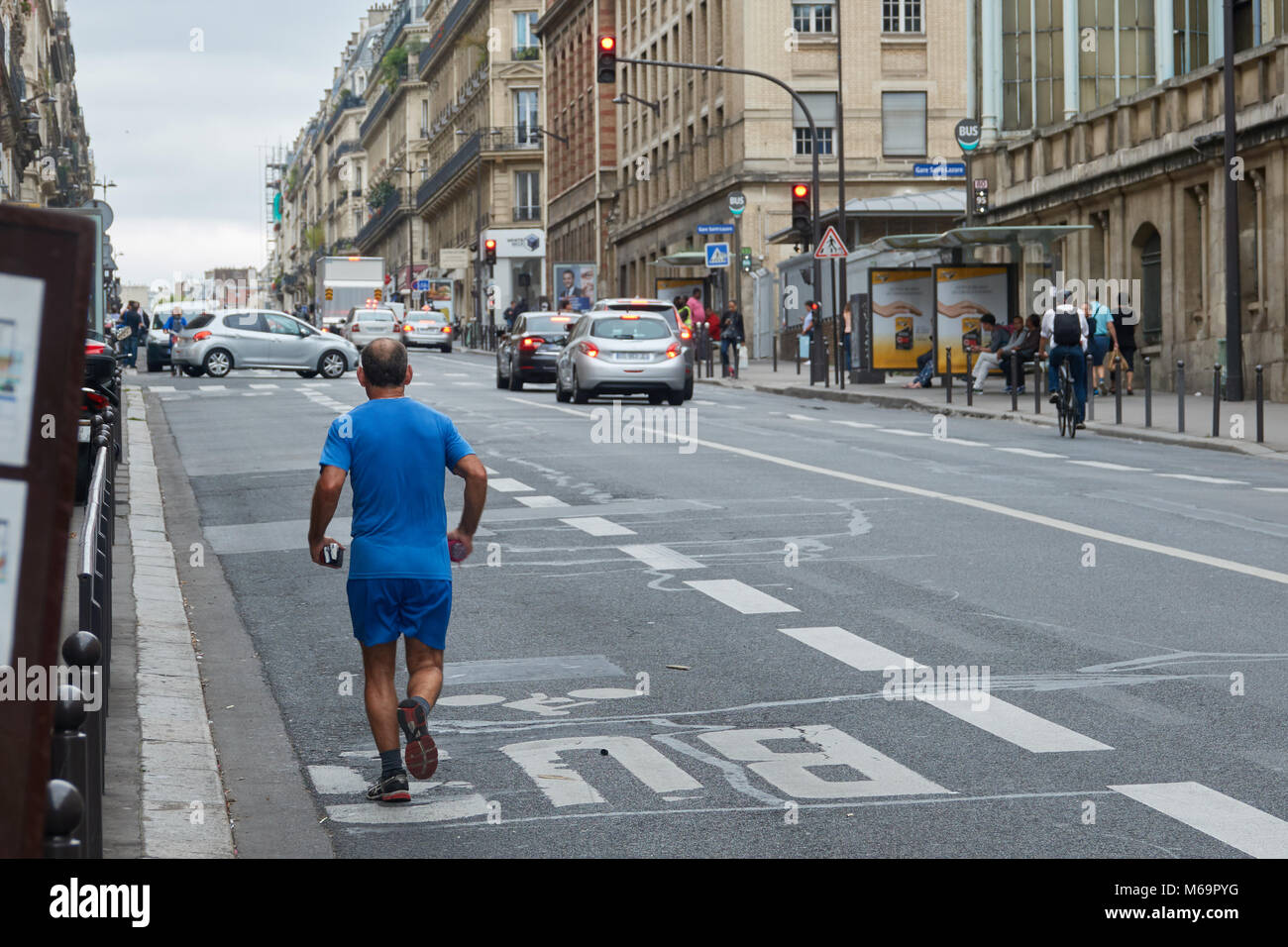 A man runs around the streets of Paris in the morning. Stock Photo