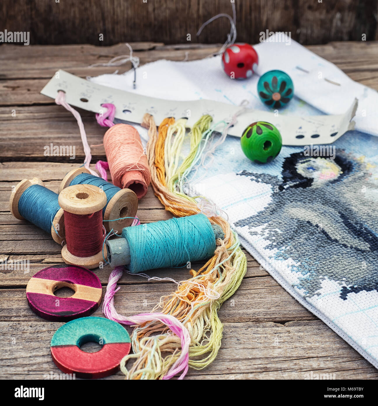 Yarn and thread for embroidering on cloth by hand on a wooden surface