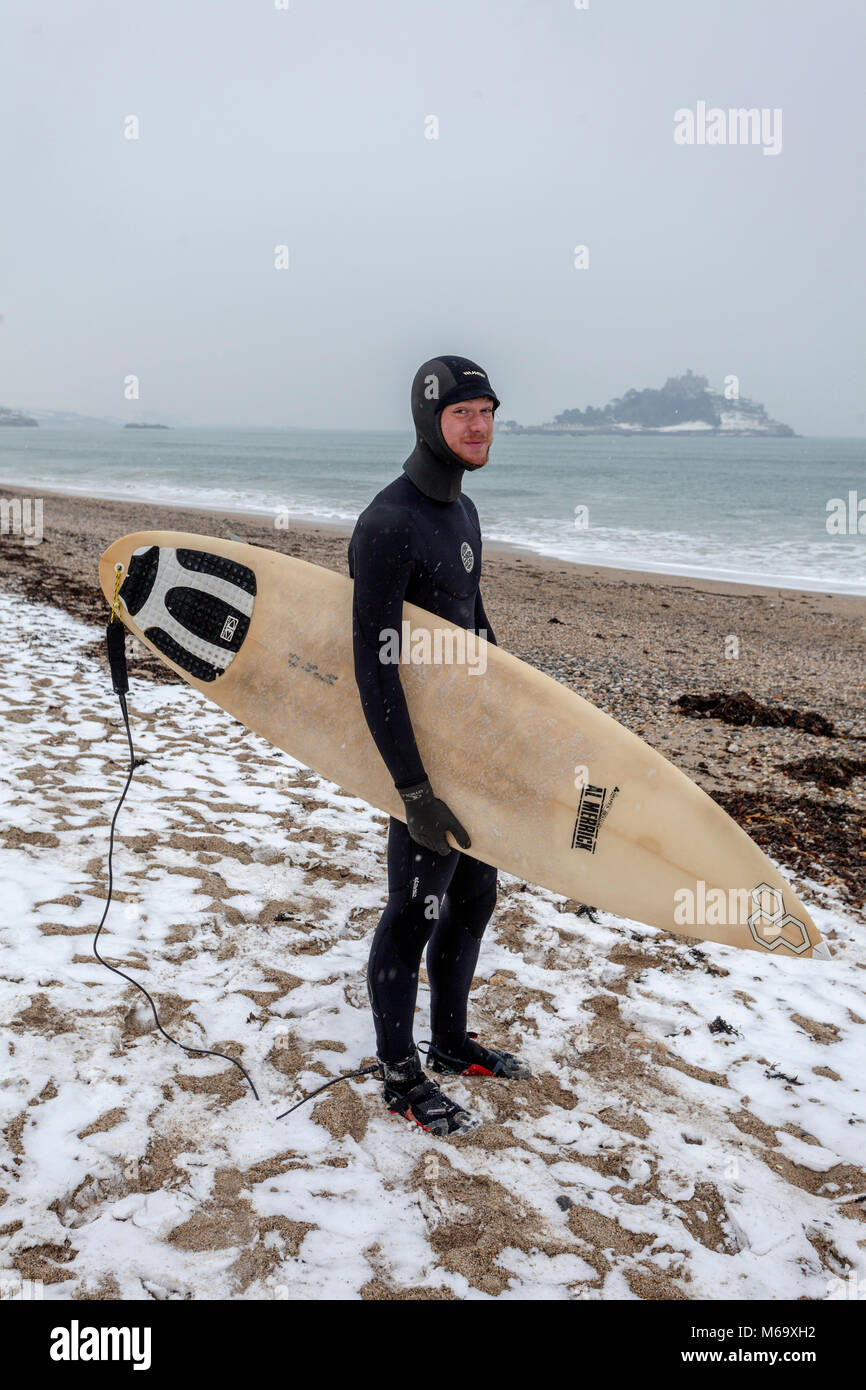 Marazion, Cornwall. 1st Mar, 2018. UK Weather. Marazion, Cornwall UK. 20 year old Brad Morris goes for a sub-zero surf at St Michael's Mount, Marazion, during the Beast from the East phenomenon.  Credit Mike Newman/AlamyLiveNews Stock Photo