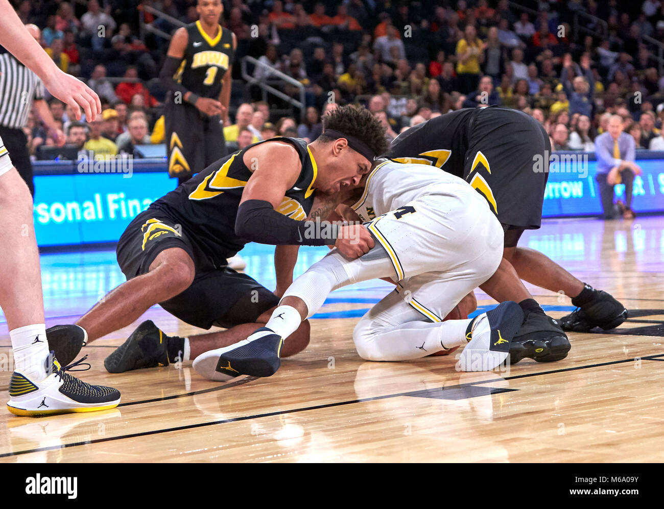 New York, New York, USA. 1st Mar, 2018. Iowa Hawkeyes forward Ahmad Wagner (0) and Michigan Wolverines guard Charles Matthews (1) battle for a loose ball during the second round of Big Ten Conference Tournament play at Madison Square Garden in New York City. Michigan defeats Iowa in over time 77-71. Duncan Williams/CSM/Alamy Live News Stock Photo