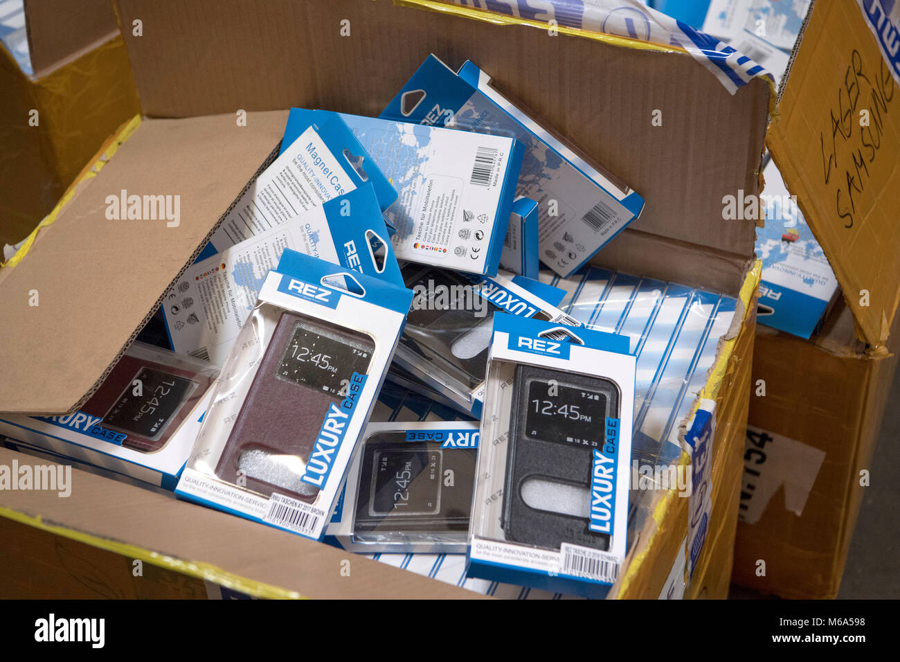 28 February 2018, Germany, Frankfurt: German customs seized fake phone cases at a secret shipping's storage at an industrial estate. In the course of police investigations customs investigators stumbled upon a company that imported huge amounts of phone cases, chargers, batteries, MP3 players and headphones of China's two leading brand manufacturers. Photo: Boris Roessler/dpa Stock Photo