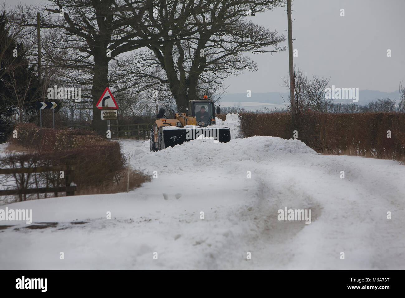 Steeple Bumpstead, Essex. 2nd Mar, 2018. UK Weather: Many roads were still un-passable today due to severe snowdrifts in Steeple Bumpstead Essex 02/03/2018 Please credit  : George Impey Picture shows a local farmer clearing snow from a road that was in places were up to six feet deep Credit: George Impey/Alamy Live News Stock Photo