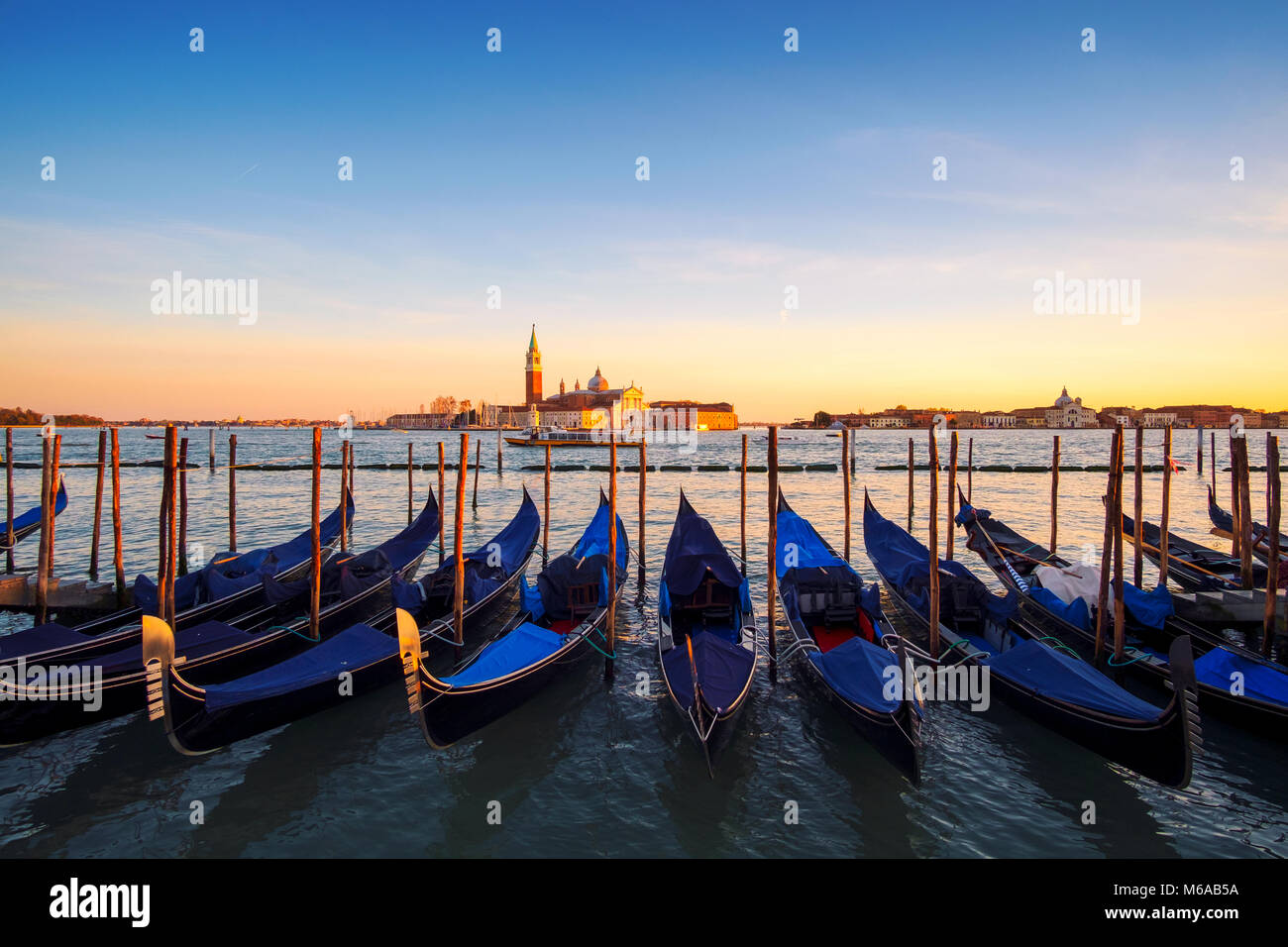 Venice with famous gondolas in lagoon at sunrise, Italy Stock Photo - Alamy