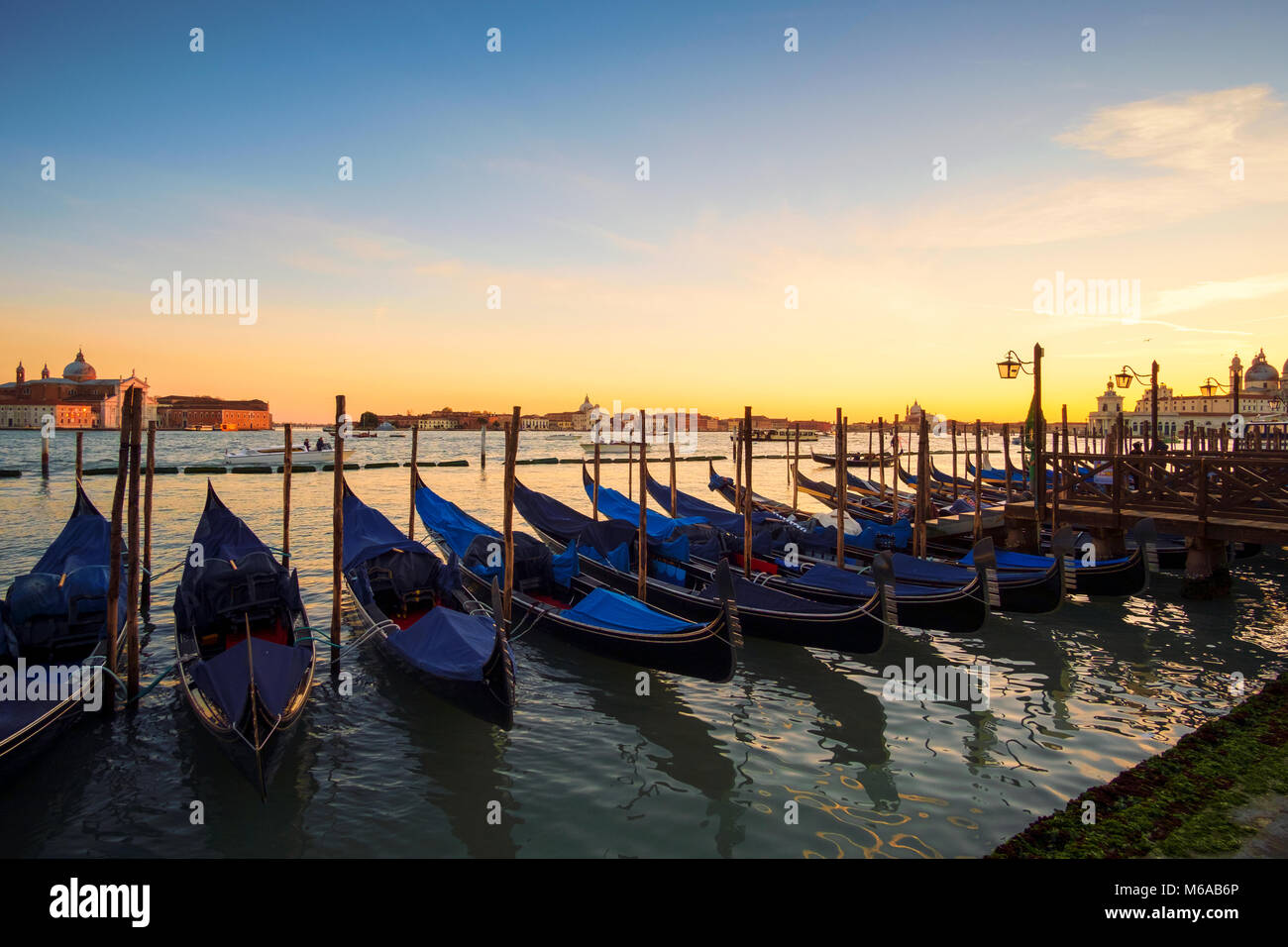 Venice with famous gondolas in lagoon at sunrise, Italy Stock Photo - Alamy
