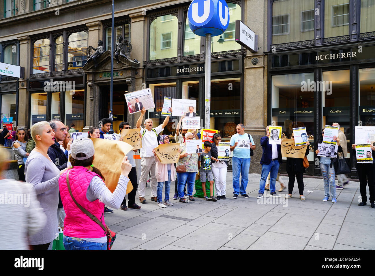 VIENNA AUSTRALIA -SEPTEMBER 3, 2017; Group protestors cqarrying placards and posters in street seeking freedom political prisoners and Mohammed Ale Ta Stock Photo
