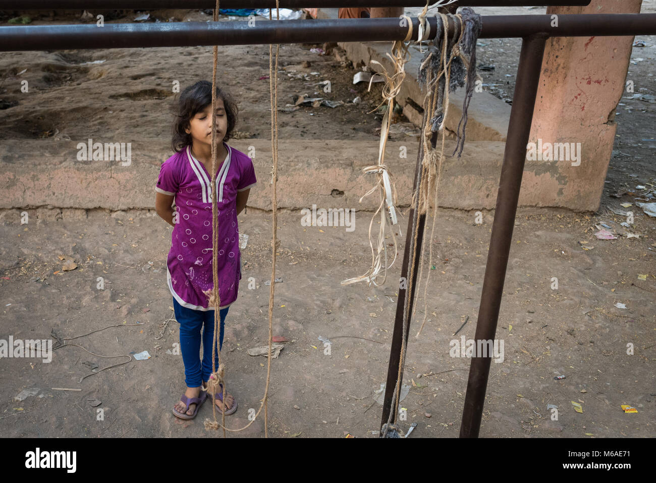 Child standing in a playground in Varanasi, India. Stock Photo