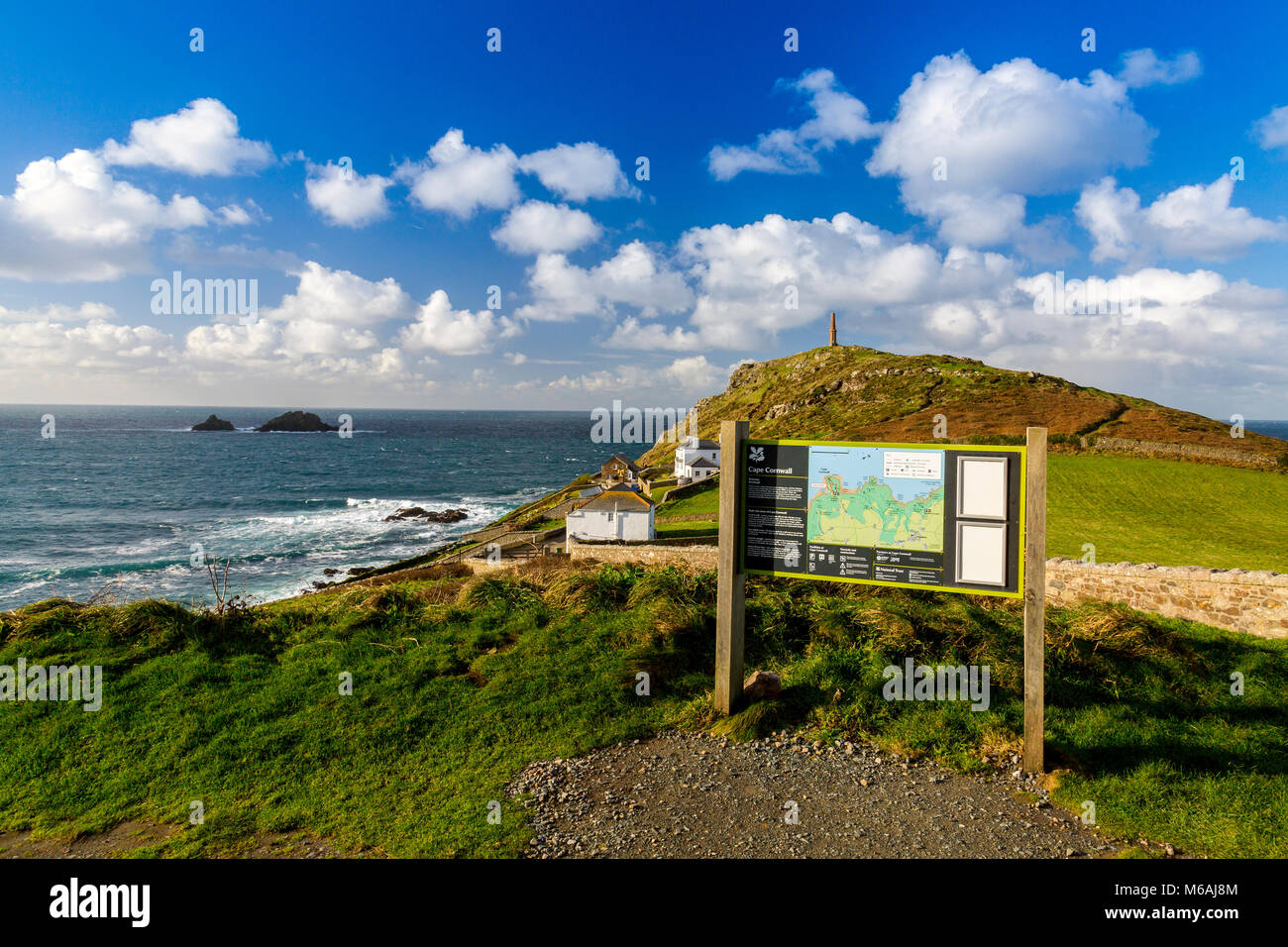 The chimney of a former tin mine now acts as a daymark for navigation around Cape Cornwall and The Brisons rocks, England, UK Stock Photo