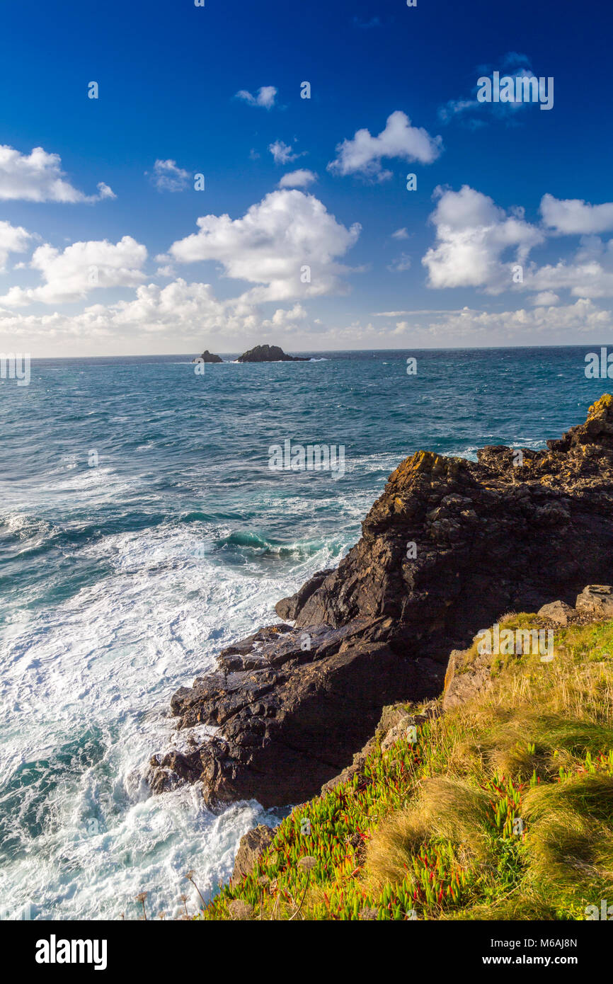 Jagged granite rocks at Cape Cornwall with the Brisons rocks beyond, Cornwall, England, UK Stock Photo