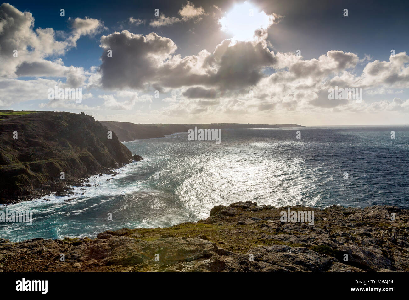 Looking south from the summit of Cape Cornwall past the derelict cliff-side remains of a former Cornish tin mine with Lands End beyond, England, UK Stock Photo
