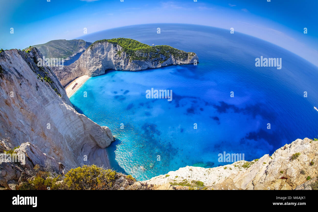 Zakynthos shipwreck beach. Navagio Bay panorama with boats and clear waters. Touristic attraction. Stock Photo